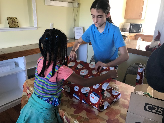 Our youth wrapping gifts to deliver to the residents during our Christmas Caroling event